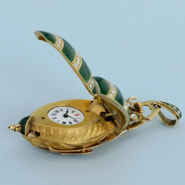 GOLD AND ENAMEL BEETLE FORM WATCH 5 1